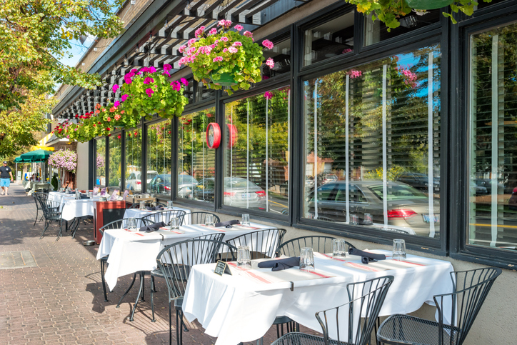 Restaurant patio filled with lush greeneries setup for outdoor dining