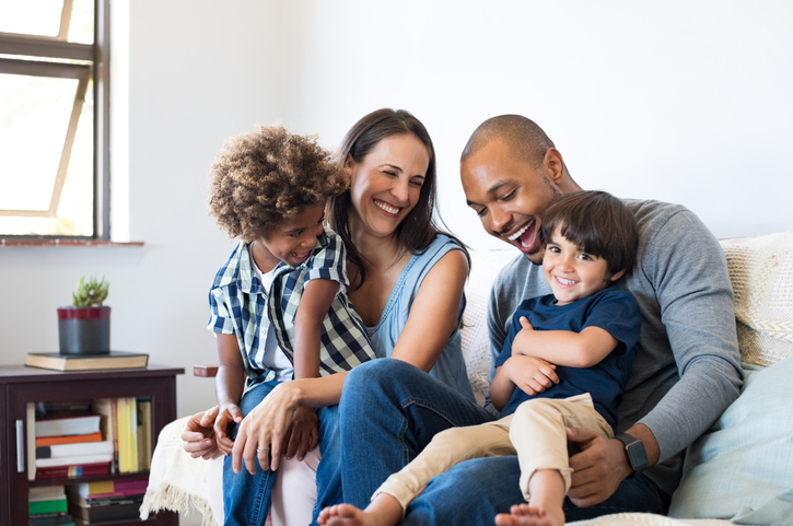 Bicultural family hanging out and having fun at home