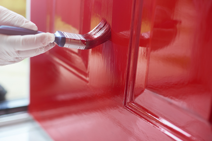 Painting a door red for using a paintbrush