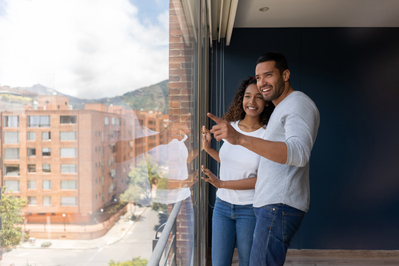 A couple looking out the window in their flat