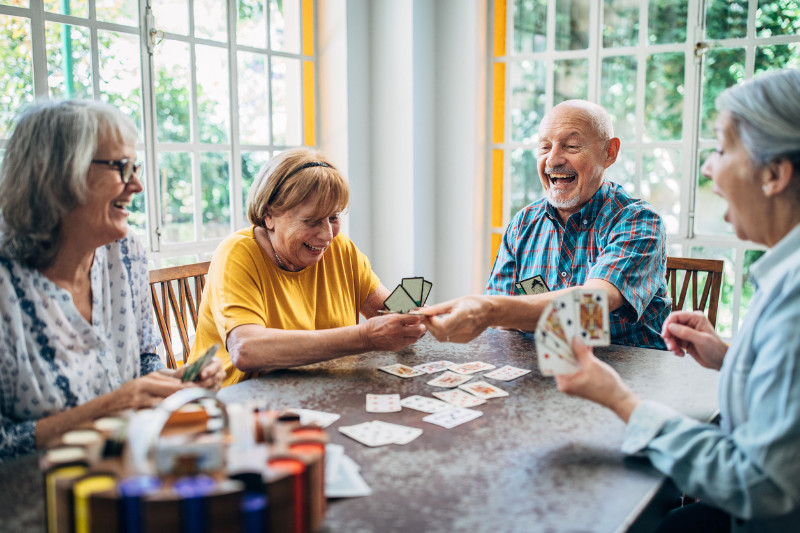 Old people having fun playing cards